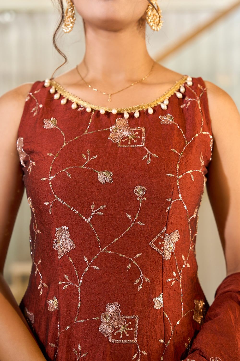 Rust-colored Zarmina embroidered kurta set with intricate embroidery, traditional Indianvirasat design, displayed on a mannequin.
