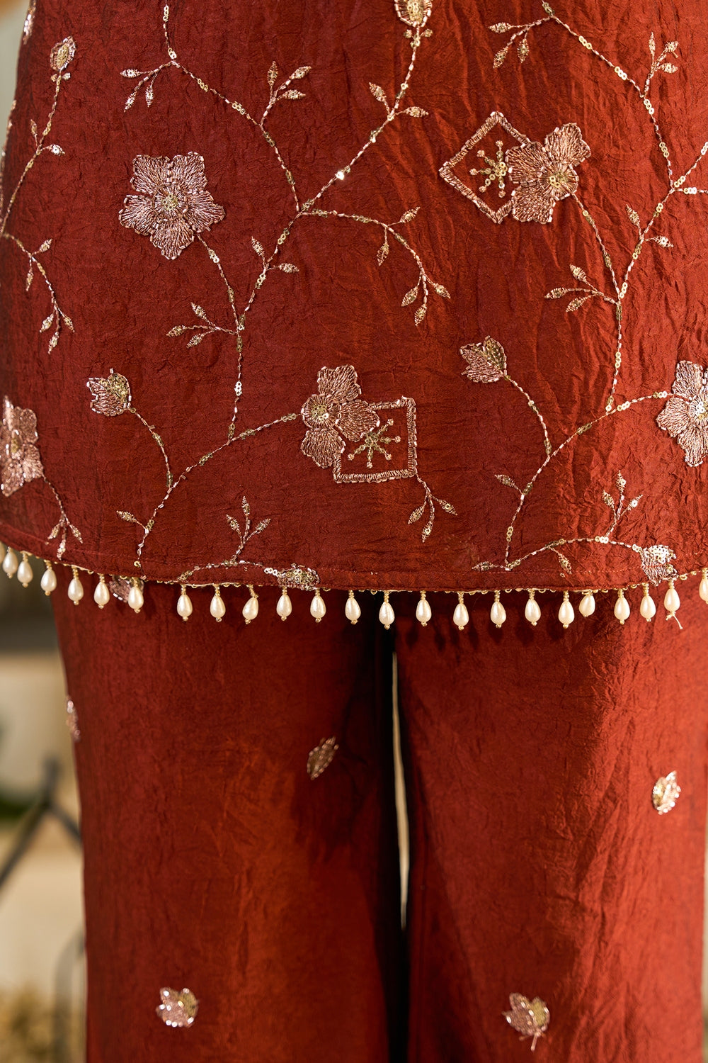Rust-colored Zarmina embroidered kurta set with intricate designs from Indianvirasat, featuring traditional Indian attire.