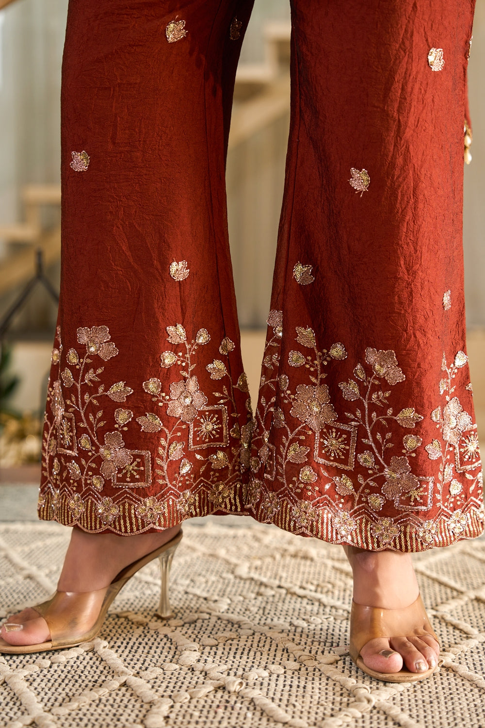 Rust-colored Zarmina embroidered kurta set by Indianvirasat with intricate embroidery and traditional design, displayed on a hanger.