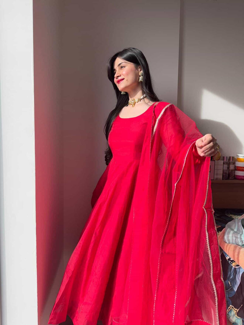Elegant red Anarkali suit set by Indian Virasat featuring intricate embroidery and flowing fabric, perfect for festive occasions.