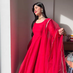 Elegant red Anarkali suit set by Indian Virasat featuring intricate embroidery and flowing fabric, perfect for festive occasions.