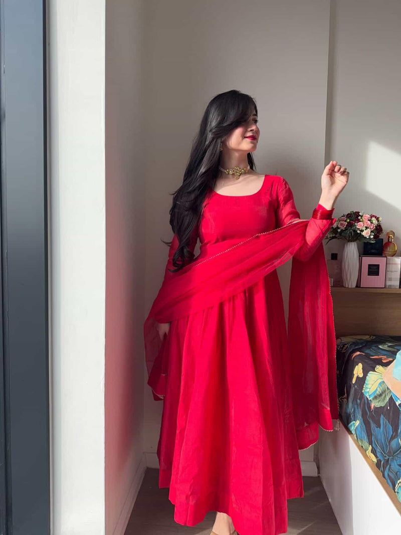 Red Anarkali suit set by Indian Virasat featuring intricate embroidery and flowing fabric, perfect for traditional occasions.