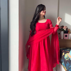 Red Anarkali suit set by Indian Virasat featuring intricate embroidery and flowing fabric, perfect for traditional occasions.