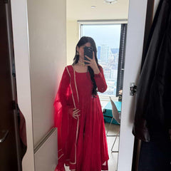 Red Anarkali suit set by Indian Virasat featuring intricate embroidery and flowing fabric, ideal for traditional occasions.