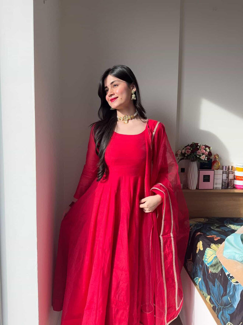 Elegant red Anarkali suit set by Indian Virasat featuring intricate embroidery and flowing fabric, perfect for festive occasions.