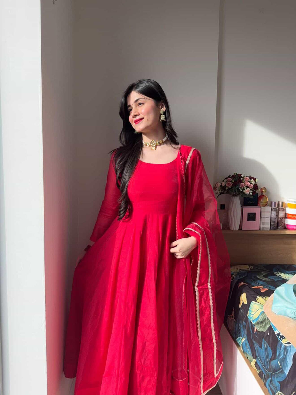 Elegant red Anarkali suit set by Indian Virasat featuring intricate embroidery and flowing fabric, perfect for festive occasions.